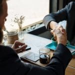 Business agreement handshake at coffee shop