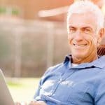 64580788 – handsome senior man with notebook sitting in the park