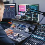 Sound engineer working in studio with equipment