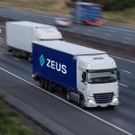 Lorries in motion. Evening traffic on the motorway.